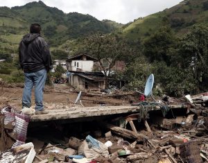 epa05465597 A resident stands amongst the debris from damaged buildings caused by a landslide, in the municipality of Huauchinango, Mexico, 08 August 2016. Heavy rains caused by Tropical Storm Earl in Mexico have left at least 45 dead. EPA/Hugo Ortuno