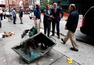 New York Mayor Bill de Blasio (2-R) and New York Governor Andrew Cuomo (3-R) and unidentified police officers stand in front of a mangled dumpster while touring the site of an explosion that occurred overnight in the Chelsea neighborhood of New York, New York, USA, 18 September 2016. Over 20 people were injured in blast. The motive is still being investigated, despite authorities assuming it is apparently not linked to international terrorism. EPA/JUSTIN LANE
