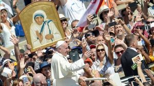 Pope Francis C waves to faithful as he leaves after a Holy Mass and the canonisation of Mother Teresa of Kolkata on Saint Peter square in the Vatican on September 4 2016 Mother Teresa the nun whose work with the dying and destitute of Kolkata made her a global icon of Christian charity was made a saint on September 4 2016 Her elevation to Roman Catholicism s celestial pantheon came in a canonisation mass in St Peter s square in the Vatican that was presided over by Pope Francis in the presence of 100 000 pilgrims AFP PHOTO ANDREAS SOLARO