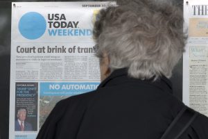 Joanna Strauss of New York City looks at the front page of the weekend edition of the USA Today, which states that Republican presidential candidate Donald Trump is 'Unfit for the Presidency', according to the newspaper's editorial board; on display outside the Newseum in Washington, DC, USA, 30 September 2016. The newspaper has made news by declaring Trump 'unfit for the presidency' - the first time the publication's editorial board has publicly taken a side in a US presidential race. EPA/MICHAEL REYNOLDS