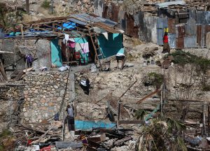 Inhabitants walk near destroyed houses in Jeremie, Haiti, 12 October 2016. Despair starts to spread among the population of Haiti due to the lack of food and water eight days after hurricane Matthew hit the city. EFE/Orlando Barria