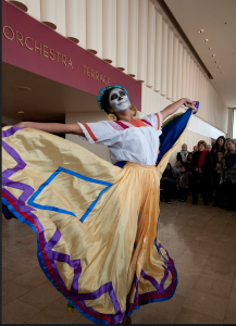 Dancer welcomes spectators to the show of Day of the Dead.