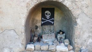 Niche in the wall displays pirate memorabilia.