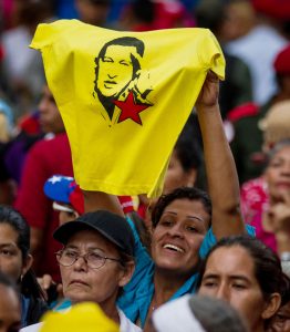 A woman raises a t-shirt with an image of late Venezuelan President Hugo Chavez, during a rally to support Venezuelan President Nicolas Maduro, in Caracas, Venezuela, 28 October 2016. Maduro announced that the Attorney's Office will present a lawsuit against the National Assembly (NA) for 'violating the Constitution' after the Parliament opened a process in order to determine the political responsibilities of the Head of State. EPA/MIGUEL GUTIERREZ