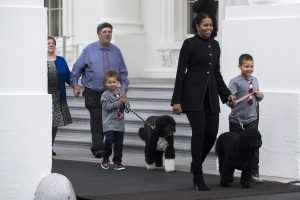 First Lady Michelle Obama (R-2), and the 2016 winners of the National Christmas Tree Association national tree contest, Mary Vander Velden (L) Dave Vander Velden (L-2) and Michelle Obama's nephews Austin (L-3) and Aaron Robinson (R), emerge to welcome the arrival of the Official White House Christmas Tree to the White House in Washington, DC, USA, 25 November 2016. This year's White House Christmas Tree is a 19 foot Balsam Fir donated by a tree farm in Wisconsin. It will be on display in the Blue Room at the White House. EPA/SHAWN THEW